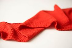 an orange cloth laying on top of a white table