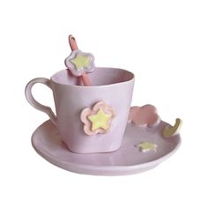 a pink cup and saucer with stars on it