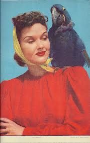 a woman with a parrot on her shoulder