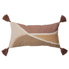 a brown and white pillow with tassels on the sides, sitting on a white background