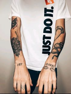 a man with tattoos on his arms and hands