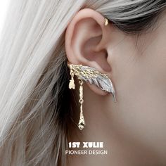 Wings of Angels High-Quality Materials: Presenting the Lucifer 18K Gold Plated Feather Ear Clips™, available in two alluring variants: A. Gold Variant:Crafted with precision using an opulent 18k real gold-plated coating for enduring radiance.Adorned with exquisite white agate, known for its timeless beauty and calming properties. B. Black Variant:Made with premium materials, featuring an 18k real black platinum-plated finish that combines durability with sophistication.Embellished with synthetic Biblically Accurate Angel, Wire Wrapping Jewelry, Wrapping Jewelry, Ear Pins, Character Clothing, Gold Feathers, Ring Trends, Gold Ear Cuff, Feather Jewelry