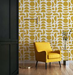 a yellow chair sitting in front of a wall with an abstract pattern on it's side