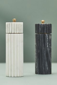 two black and white lighters sitting next to each other on top of a table