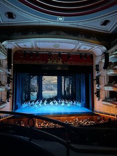 an auditorium filled with lots of people on stage