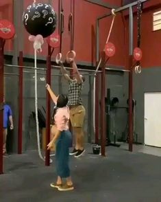 two children are playing with balloons in the gym