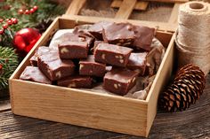 a wooden box filled with brownies next to christmas decorations