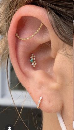 a woman wearing ear piercings with two different designs