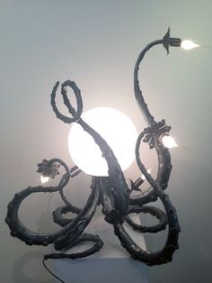 an octopus lamp with two lights on each side and one light attached to the back