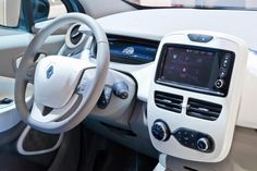 the interior of a car with steering wheel, dashboard and display screen showing various buttons