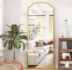 a living room filled with furniture and a large mirror in the middle of the room