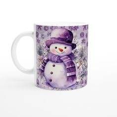 a coffee mug with a snowman wearing a purple hat, scarf and mittens