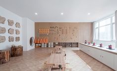 an empty room with wooden tables and benches