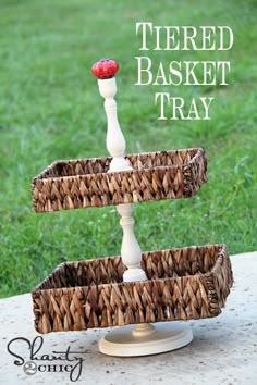 a three tiered wicker basket with a strawberry on top