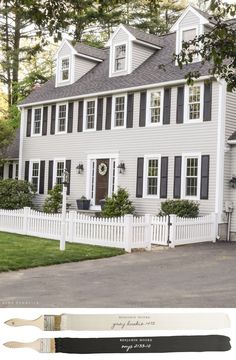 a white house with black shutters on the front, and a painting brush in front