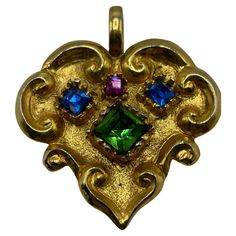 Christian Lacroix Gold Toned Pendant. Adorn with blue pink and a green crystal rock in the center. This heart-shaped pendant is rare and in excellent condition. Christian Lacroix's signature is on the back. London Soho, Rose Bleu, Green Crystal, Christian Lacroix, Green Crystals, Jewelry Necklace Pendant, Gold Tones, Jewelry Necklaces, Pendant Necklace