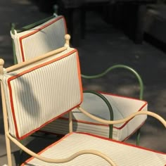 two chairs sitting next to each other on the ground