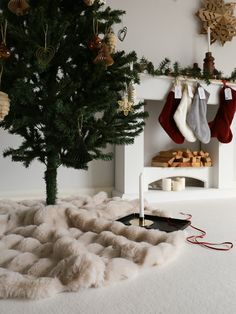 a christmas tree with stockings hanging from it