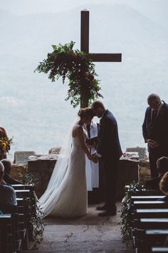 a bride and groom are getting married at the alter