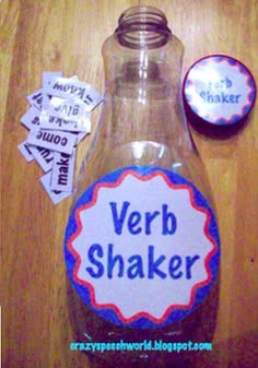 a bottle with some words in it on a wooden table next to two magnets that say verbb shaker