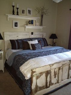 a bedroom with a bed, nightstands and two lamps on either side of the bed