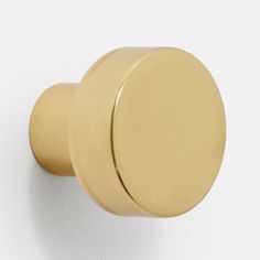 a gold door knob on a white wall