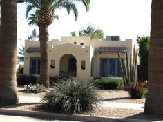 a house with palm trees in front of it