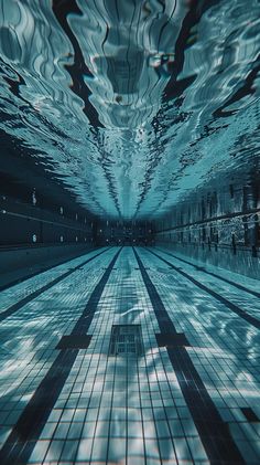 an underwater swimming pool with tiled flooring and sky reflected in the water's surface