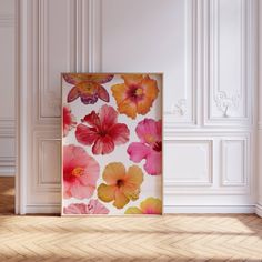 an empty room with white walls and pink flowers on the wall in front of it