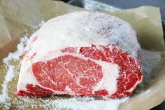 a piece of raw meat is covered in powdered sugar and sits on wax paper