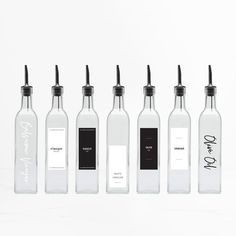 six empty bottles with black and white labels