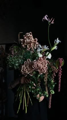 a person holding a bunch of flowers in their hands