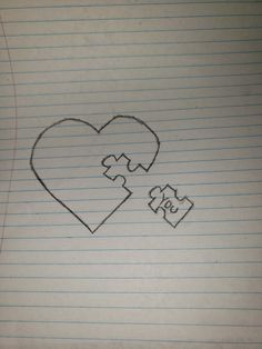 a piece of paper that has been drawn to look like a heart and two pieces of puzzle