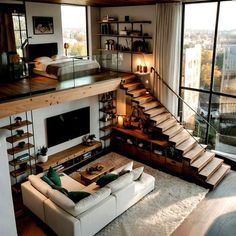 a living room filled with furniture and lots of windows next to a staircase leading up to a bed