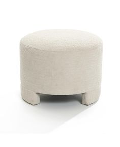 a white ottoman sitting on top of a wooden table