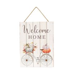 a wooden sign that says welcome home with a bicycle and pumpkins on the front