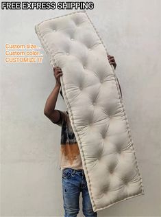 a man is holding up a mattress in front of his face with the words free express shipping