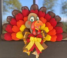 a fake turkey head hanging on the side of a window sill in front of a door