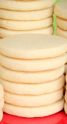 a stack of cookies sitting on top of a red plate next to each other with white frosting