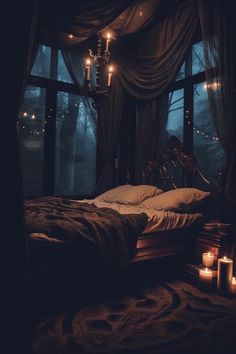 a bed in a dark room with candles on the floor next to it and a chandelier hanging from the ceiling