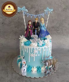 a frozen princess birthday cake with figurines on top