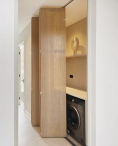 a washer and dryer in a room with wooden partitions on the wall