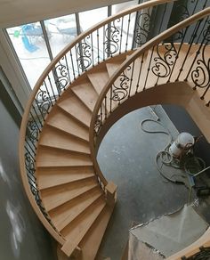 there is a spiral staircase in the middle of a building with metal handrails