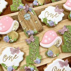 some decorated cookies are on a wooden tray