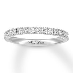 a white gold wedding band with round cut diamonds on the side and words, not love