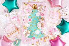 a pink and blue christmas card surrounded by balloons, stars, and confetti