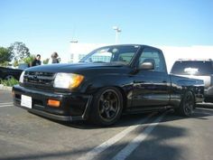 a black truck parked in a parking lot