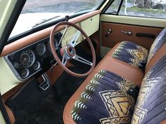 the interior of an old car is decorated with native patterns and leather seats are upholstered