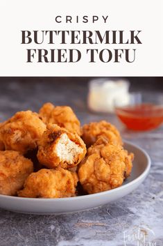 crispy buttermilk fried tofu on a plate with dipping sauce in the background