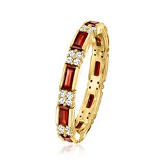 a yellow gold ring with red and white stones on the inside, surrounded by diamonds